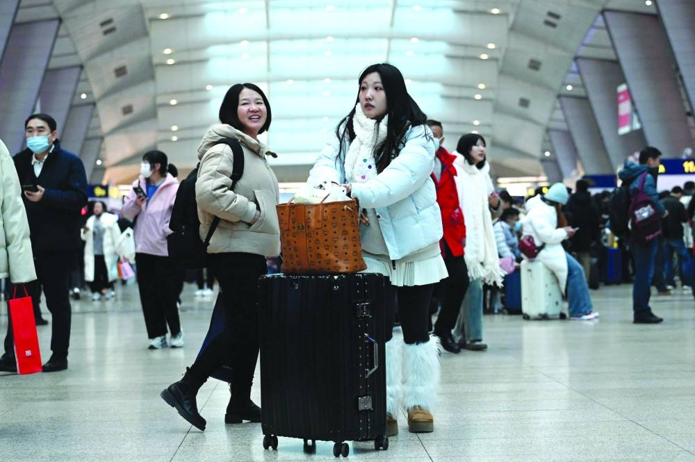 Passengers wait to check in at a railway station in Beijing on January14, 2025, as the first day of the annual migration, known as Chunyun, with people heading back to their hometowns for Lunar New Year celebrations. (Photo by WANG Zhao / AFP)