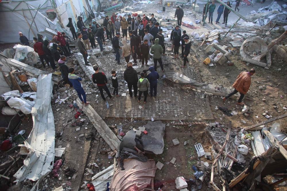 People check the destruction in the aftermath of an Israeli strike at the  Al-Farabi school in the centre of Gaza City, which is sheltering a number of displaced people, on Wednesday. AFP
