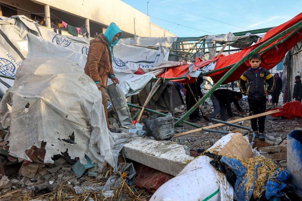 People check the destruction in the aftermath of an Israeli strike at the  Al-Farabi school in the centre of Gaza City, which is sheltering a number of displaced people, on Wednesday. AFP