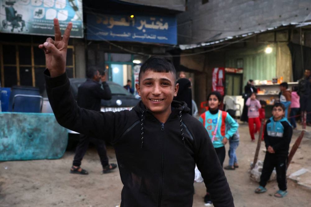 A boy celebrates along a street in Khan Yunis in the southern Gaza Strip. AFP