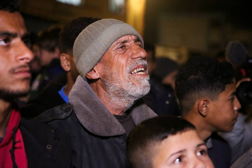 Palestinians react as they wait for news of a ceasefire deal with Israel, in Khan Younis in the southern Gaza Strip, Wednesday. REUTERS