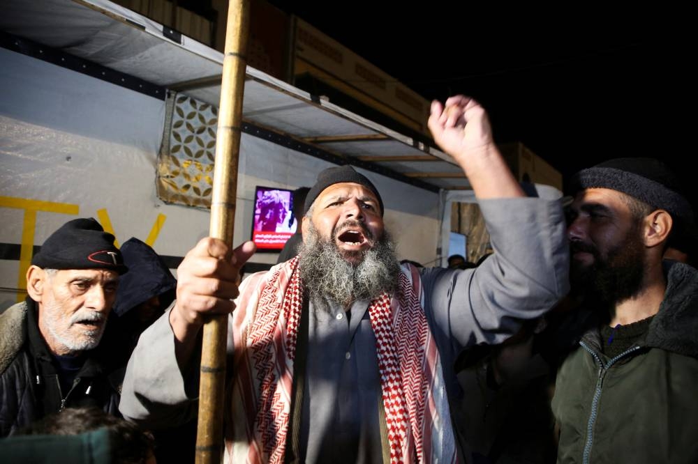 Palestinians react to news on a ceasefire deal with Israel, in Deir Al-Balah in the central Gaza Strip, Wednesday. REUTERS