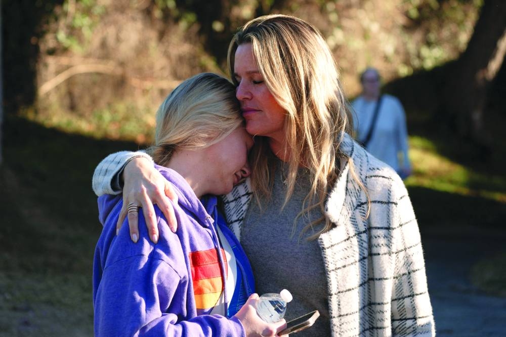Jaclyn Senis and Laura Shockley, both displaced due to the Palisades Fire, embrace after dropping their children off at a new school in the Brentwood neighbourhood in Los Angeles, California, Wednesday.