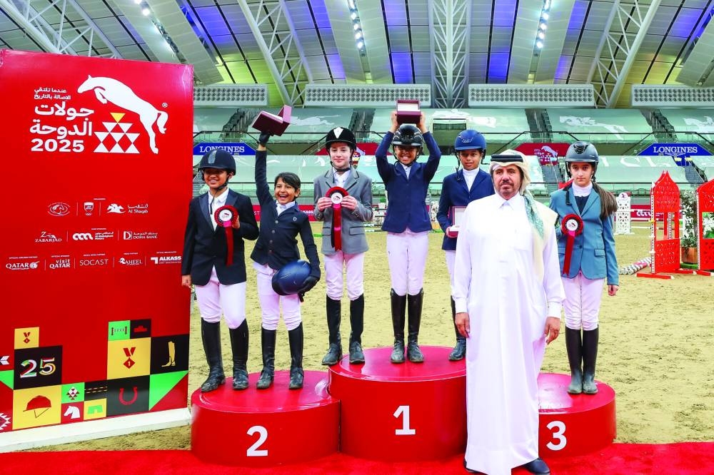 
The top six finishers of the Future Riders’ National Competition - Optimum Time - 0.60m pose on the podium with Ahmed Khalid al-Humaidi, Heritage and Heritage Specialist at Al Shaqab. 