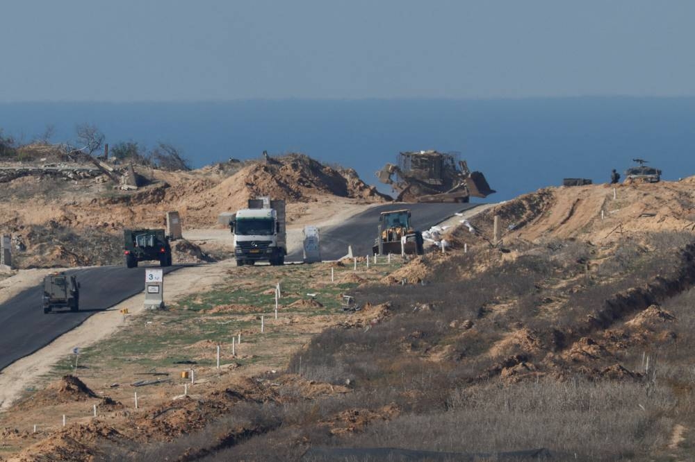Israeli military vehicles manoeuvre inside the Gaza Strip, before a ceasefire deal between Israel and Hamas goes into effect, as seen from the Israeli side of the Gaza border in southern Israel, on Saturday. REUTERS