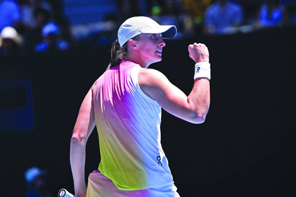 Poland’s Iga Swiatek celebrates the match point against Britain’s Emma Raducanu on Saturday. (AFP)