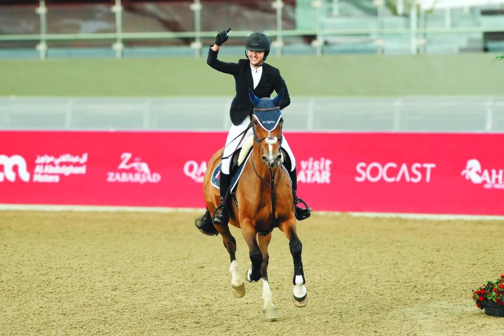 
Nayla bint Tamim bin Hamad al-Thani celebrates after winning the Optimum Time – 1.00m class at the Longines indoor arena of Al Shaqab. 