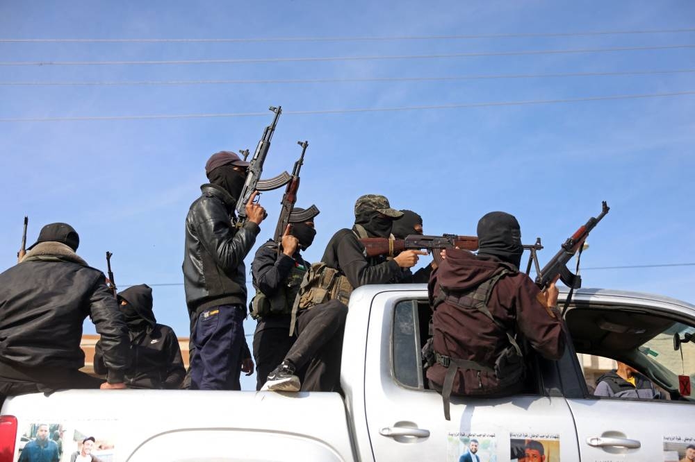 Members of Hamas's armed wing, the Ezzedine al-Qassam Brigades, take part in a military parade along a street in Deir el-Balah, in the central Gaza Strip, on Wednesday. AFP