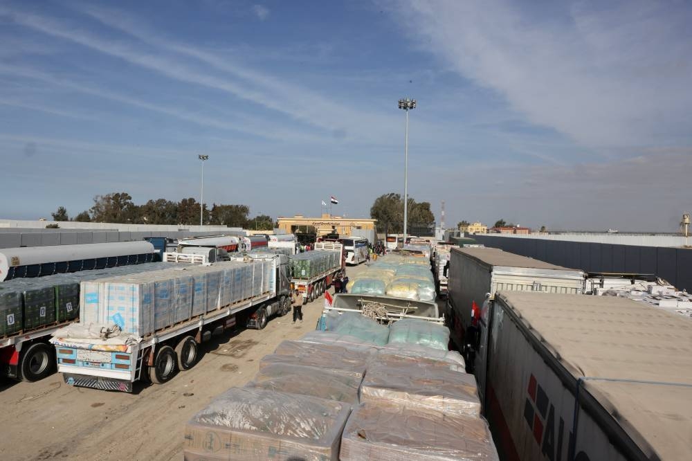 Trucks carrying aid wait at the Rafah border crossing between Egypt and the Gaza Strip, amid a ceasefire between Israel and Hamas, in Rafah, Egypt, on Sunday. REUTERS