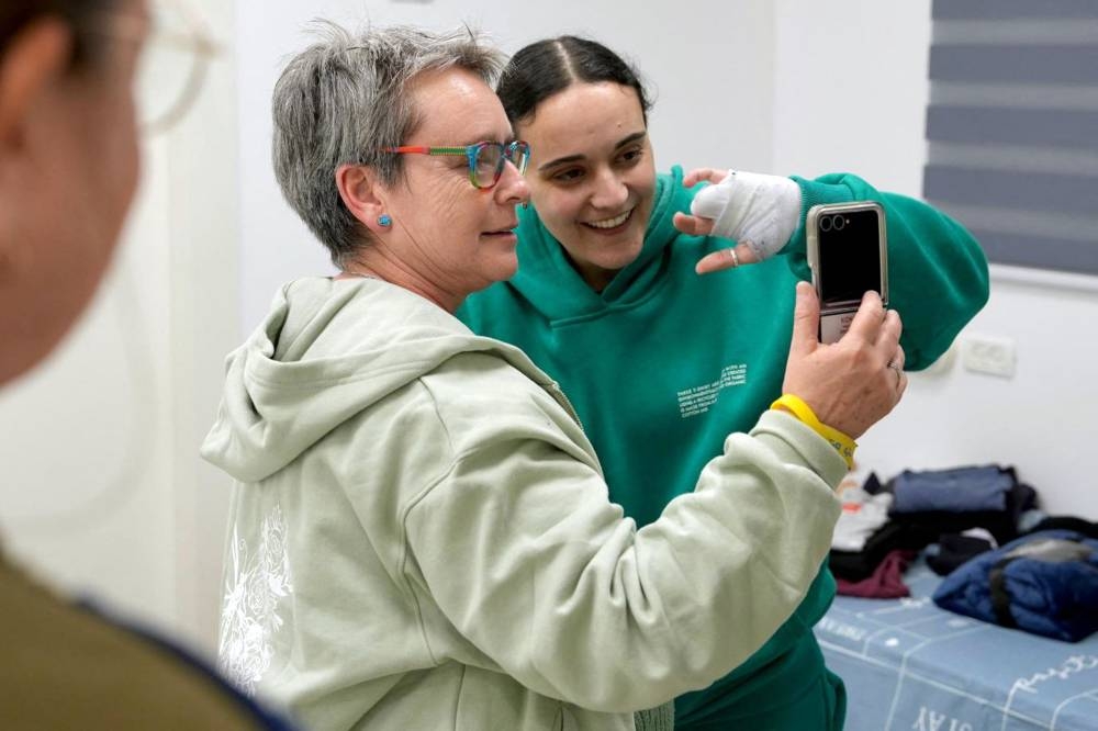 Former Israeli hostage Emily Damari with her mother Amanda at an undisclosed location in Israel on Sunday after a ceasefire and hostage-prisoner exchange deal in the war between Israel and Hamas was implemented. AFP PHOTO / Handout / Israeli Army