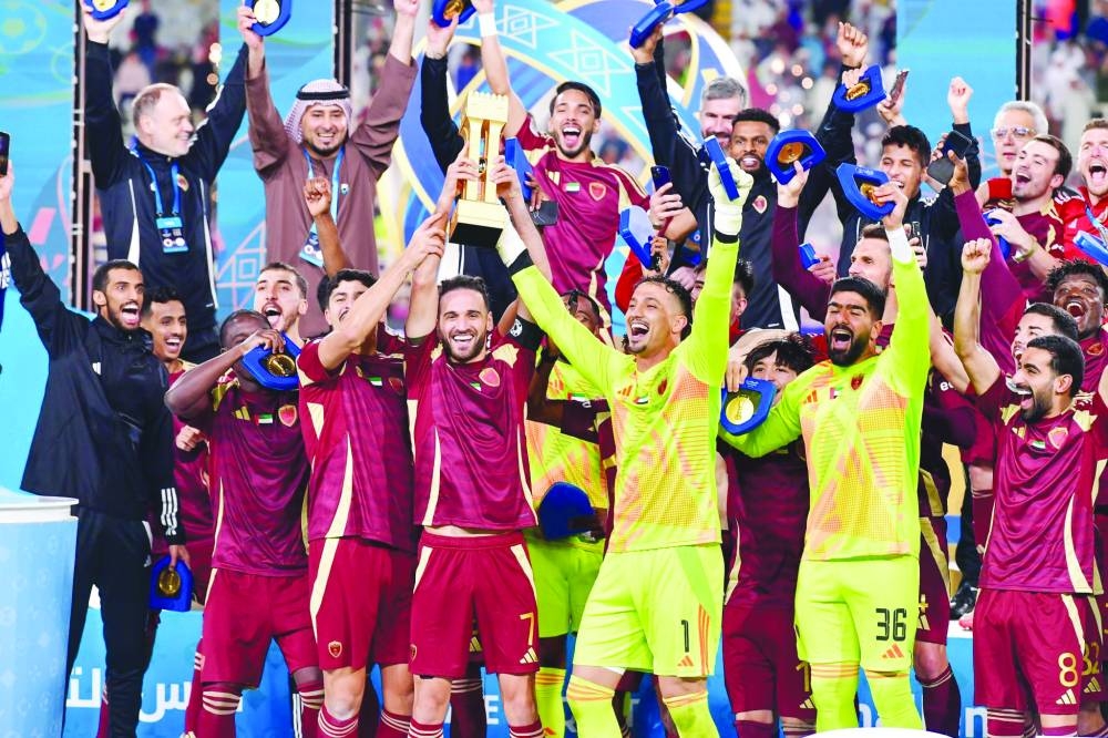 
Al Wahda players celebrate with the Challenge Cup of the Qatar-UAE Super Cup at the Al Nahyan Stadium in Abu Dhabi yesterday. 
