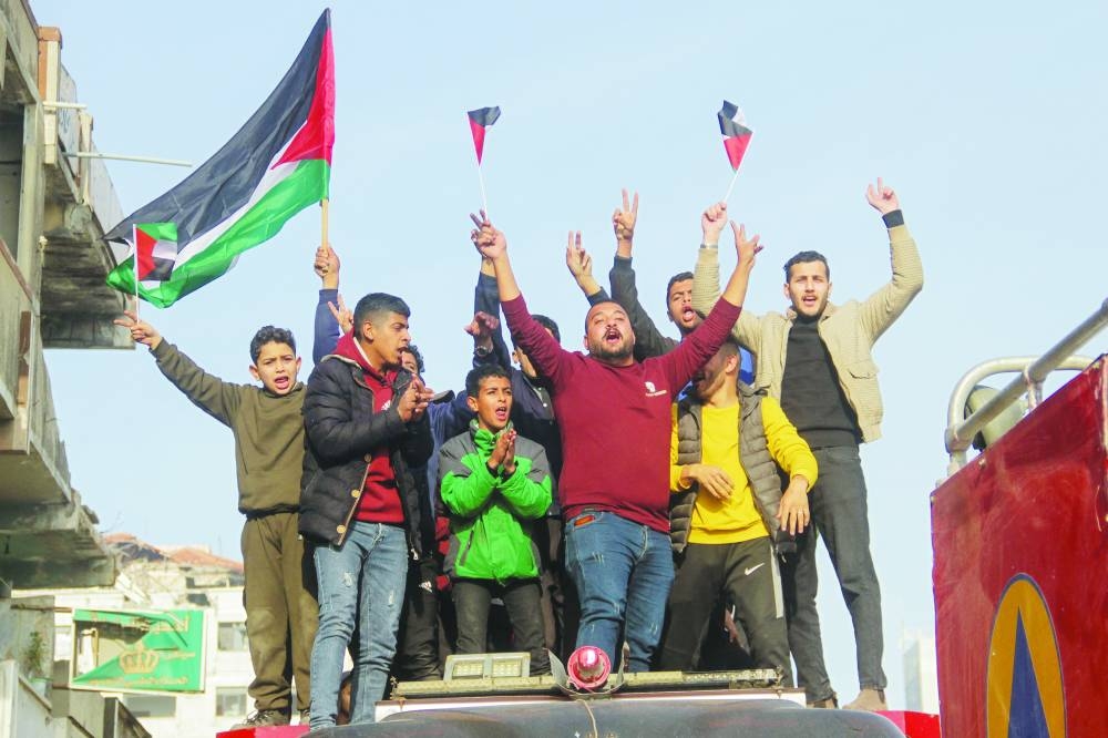 
Palestinians celebrate ceasefire between Israel and Hamas, in Gaza City, yesterday. 