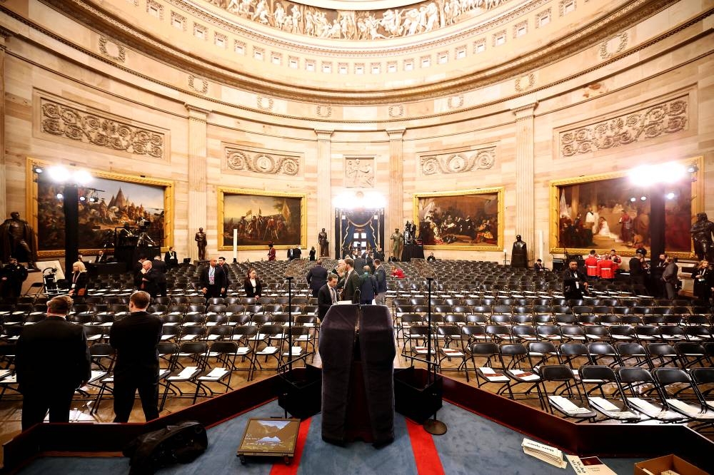 Staff prepare for the inauguration of US President-elect Donald Trump in the US Capitol Rotunda on Monday in Washington, DC. Donald Trump takes office for his second term as the 47th president of the United States.     Chip Somodevilla/Pool via REUTERS