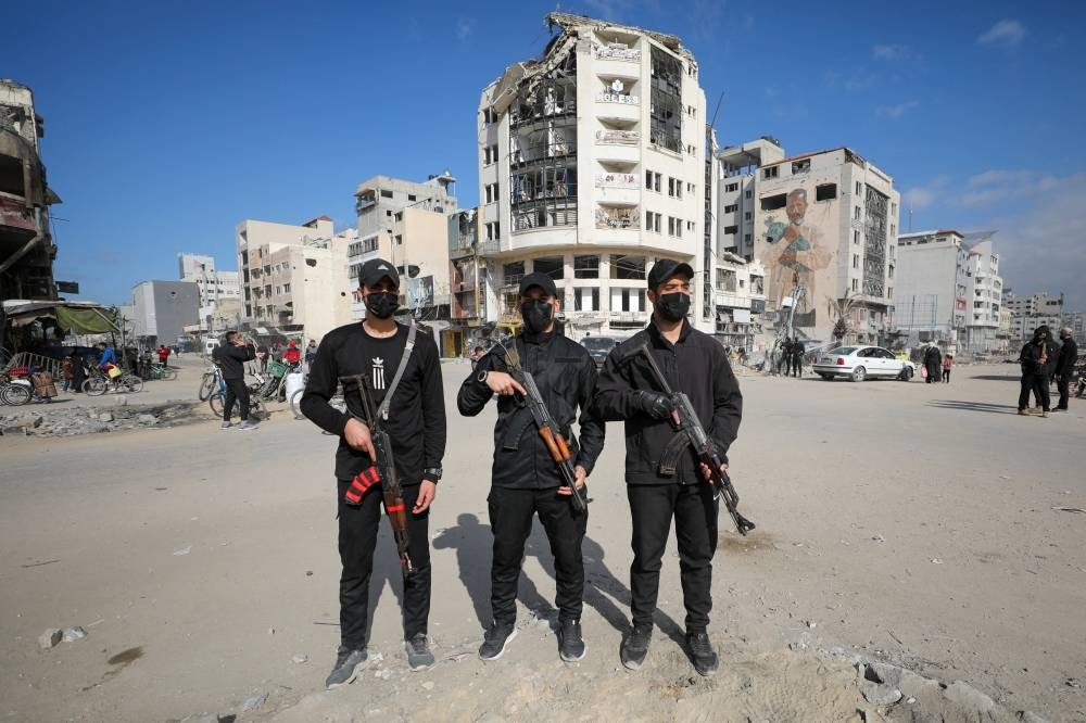 Hamas policemen stand guard after deploying in streets to maintain order, following a ceasefire between Israel and Hamas, in Gaza City, on Monday. REUTERS