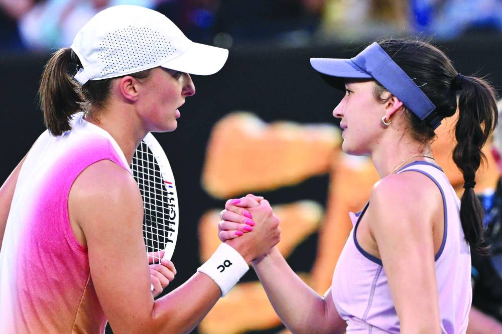 Poland’s Iga Swiatek (left) shakes hands with Germany’s Eva Lys after their singles match on day nine of the Australian Open in Melbourne on Monday. (AFP)