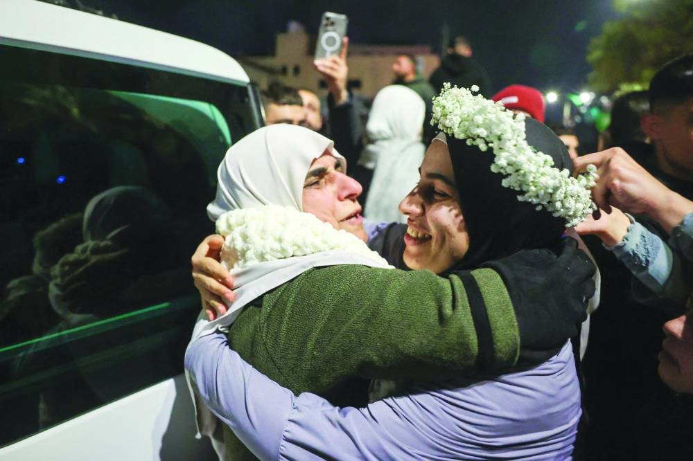 
Palestinian prisoner Baraah Fuqaha (right), is welcomed by relatives upon the arrival of some 90 prisoners set free by Israel in the early hours of yesterday in the occupied West Bank town of Beitunia, on the outskirts of Ramallah. 