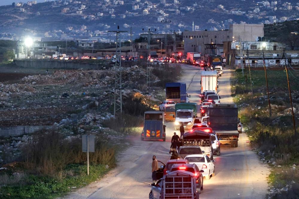 Palestinian vehicles line up to cross the Israeli controlled Bait Furik checkpoint in the occupied West Bank, east of Nablus, on Tuesday. AFP
