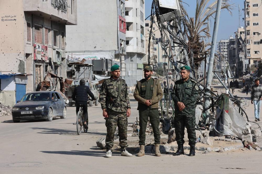 Members of security forces loyal to Hamas stand guard in Gaza City, on Tuesday. AFP