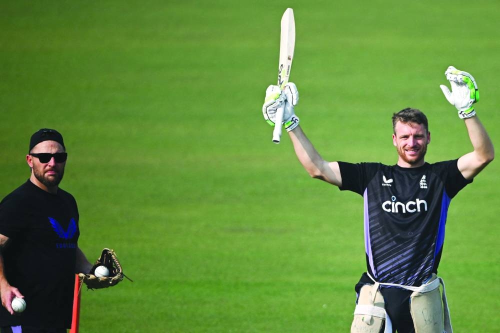 England’s captain Jos Buttler (right) with coach Brendon McCullum attends a practice session ahead of their first Twenty20I against India at the Eden Gardens in Kolkata on Tuesday. (AFP)