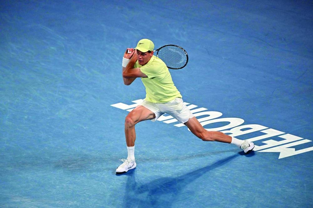 Italy’s Jannik Sinner hits a return against Australia’s Alex De Minaur during their Australian Open quarter-final in Melbourne on Wednesday. (AFP)