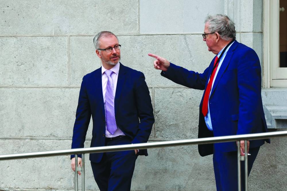 
Sinn Fein’s Eoin O’Broin walks out of parliament after it is suspended. 