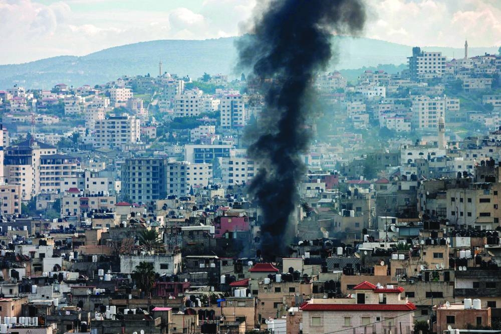 Smoke rises from an area in Jenin in the occupied West Bank during a large-scale Israeli army operation, on Friday.