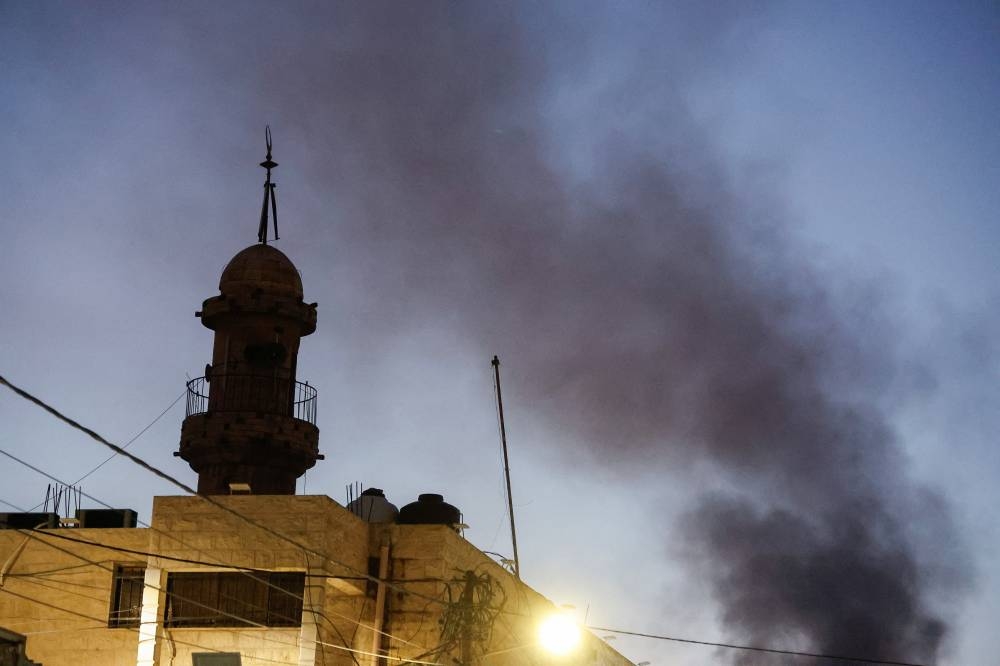 Smoke rises, on the day of an Israeli military raid, in Jenin camp, in the Israeli-occupied West Bank, on Friday. REUTERS
