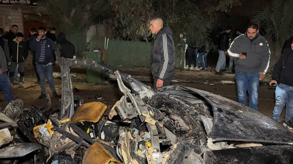 Palestinians inspect the site of a deadly Israeli strike on a car, near Jenin, in the Israeli occupied West Bank, on Friday. REUTERS