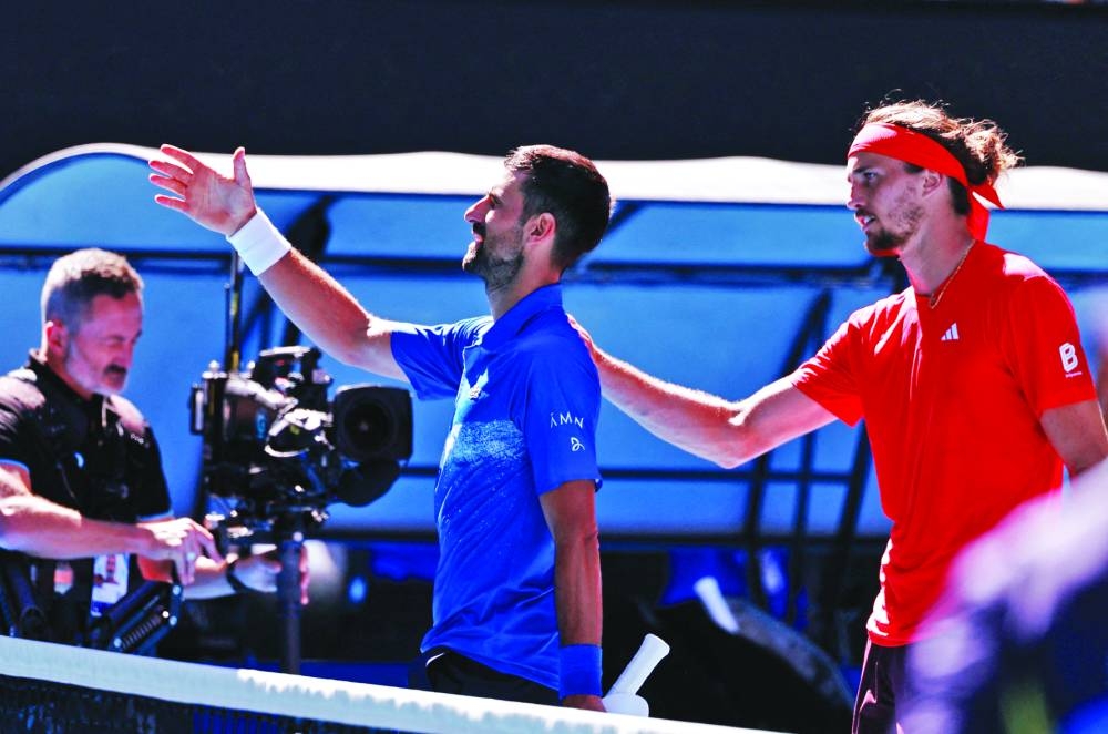 Serbia’s Novak Djokovic shakes hands with the umpire after retiring from his semi-final against Germany’s Alexander Zverev (right) at the Australian Open in Melbourne on Friday.  (Reuters)