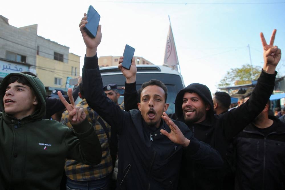 People celebrate as freed Palestinian prisoners released by Israel arrive in the southern Gaza Strip, on Saturday. REUTERS