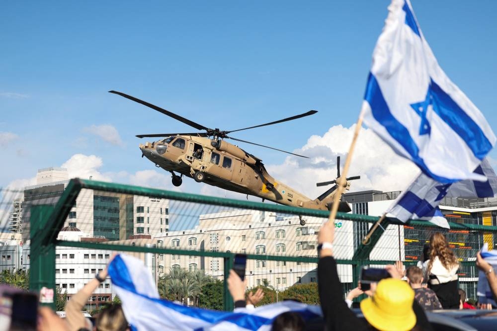 An Israeli military helicopter transporting released Israeli hostages, arrives at Beilinson Schneider complex,  in Petah Tikva, Israel,on Saturday. REUTERS