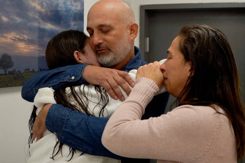Released Israeli hostage Naama Levy embraces loved ones after being released on Saturday. Israel Defense Forces/Handout via REUTERS