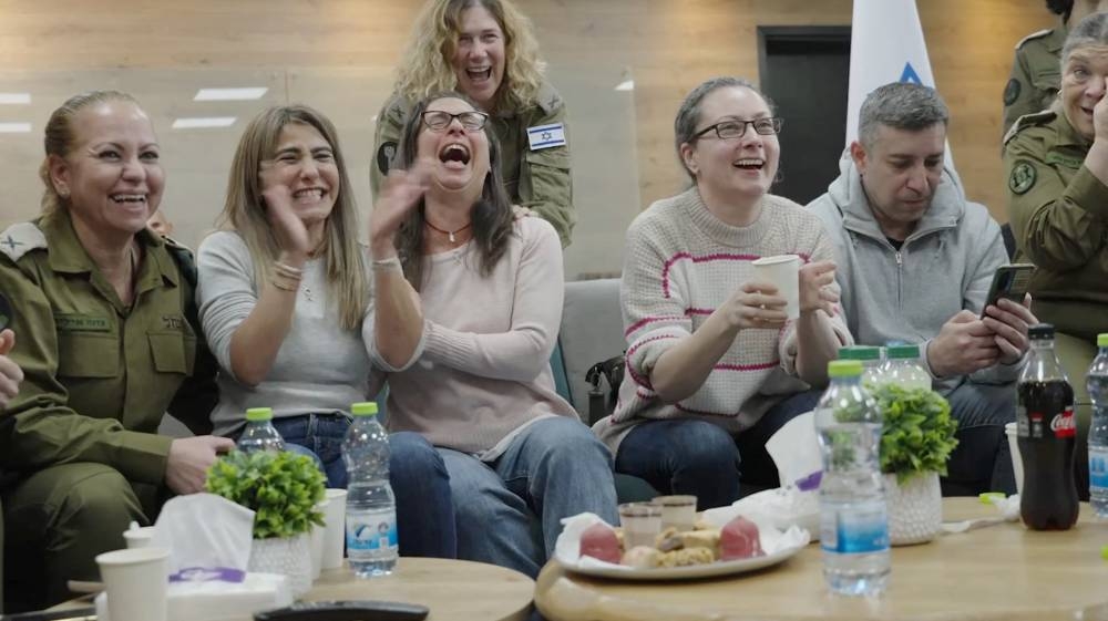 The parents of Karina Ariev, and the mothers of Naama Levy and Liri Albag react as their daughters, are transferred to the Israeli military in southern Israel,on Saturday, in this still image obtained from a video. Israel Defense Forces/Handout via REUTERS 