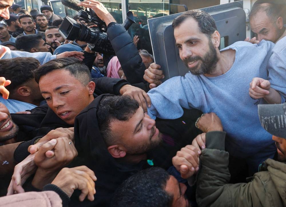 A freed Palestinian prisoner is greeted by people after being released by Israel, in Khan Younis in the southern Gaza Strip, on Saturday. REUTERS