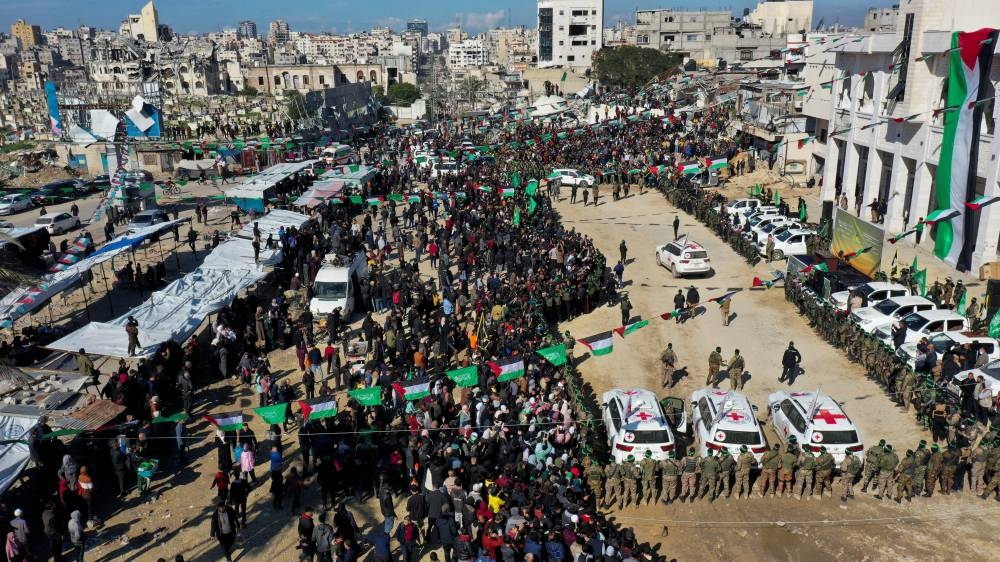 A drone view shows Palestinians, Hamas and Islamic Jihad members gathering near International Committee of the Red Cross (ICRC) vehicles on the day of the release of four female Israeli soldiers, in Gaza City, on Saturday. REUTERS