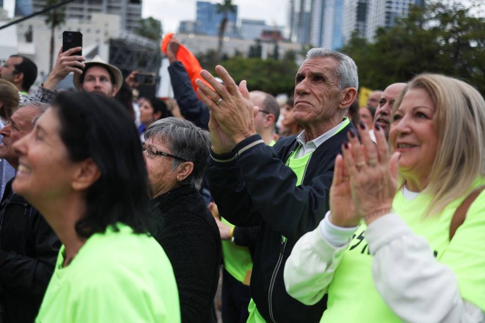 People react as they watch broadcasts related to the release of Israeli hostages at a public square dedicated to hostages in Tel Aviv, Israel, on Saturday. REUTERS