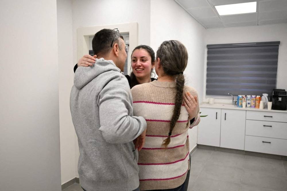 Released Israeli hostage Karina Ariev embraces loved ones after being released on Saturday. Israel Defense Forces/Handout via REUTERS