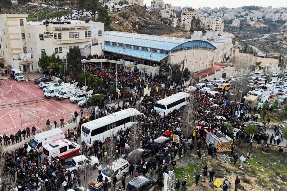 A drone view shows people gathering near buses carrying freed Palestinian prisoners after they were released from an Israeli jail, in Ramallah, in the Israeli-occupied West Bank, on Saturday. REUTERS
