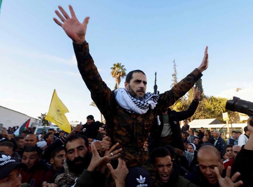 A freed Palestinian prisoner is carried by people after he was released by Israel, in Khan Younis in the southern Gaza Strip, on Saturday. REUTERS
