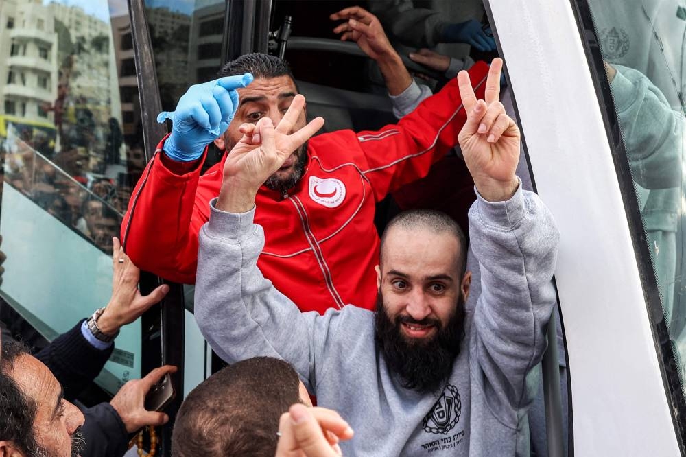 One of the Palestinian prisoners released by Israel reacts after disembarking off one of the buses of the International Committee of the Red Cross (ICRC) upon arrival in Ramallah in the occupied West Bank, Saturday.