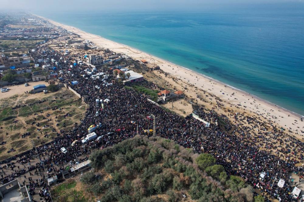 A drone view shows Palestinians waiting to be allowed to return to their homes in northern Gaza after they were displaced to the south at Israel's order during the war, in the central Gaza Strip, on Sunday. REUTERS