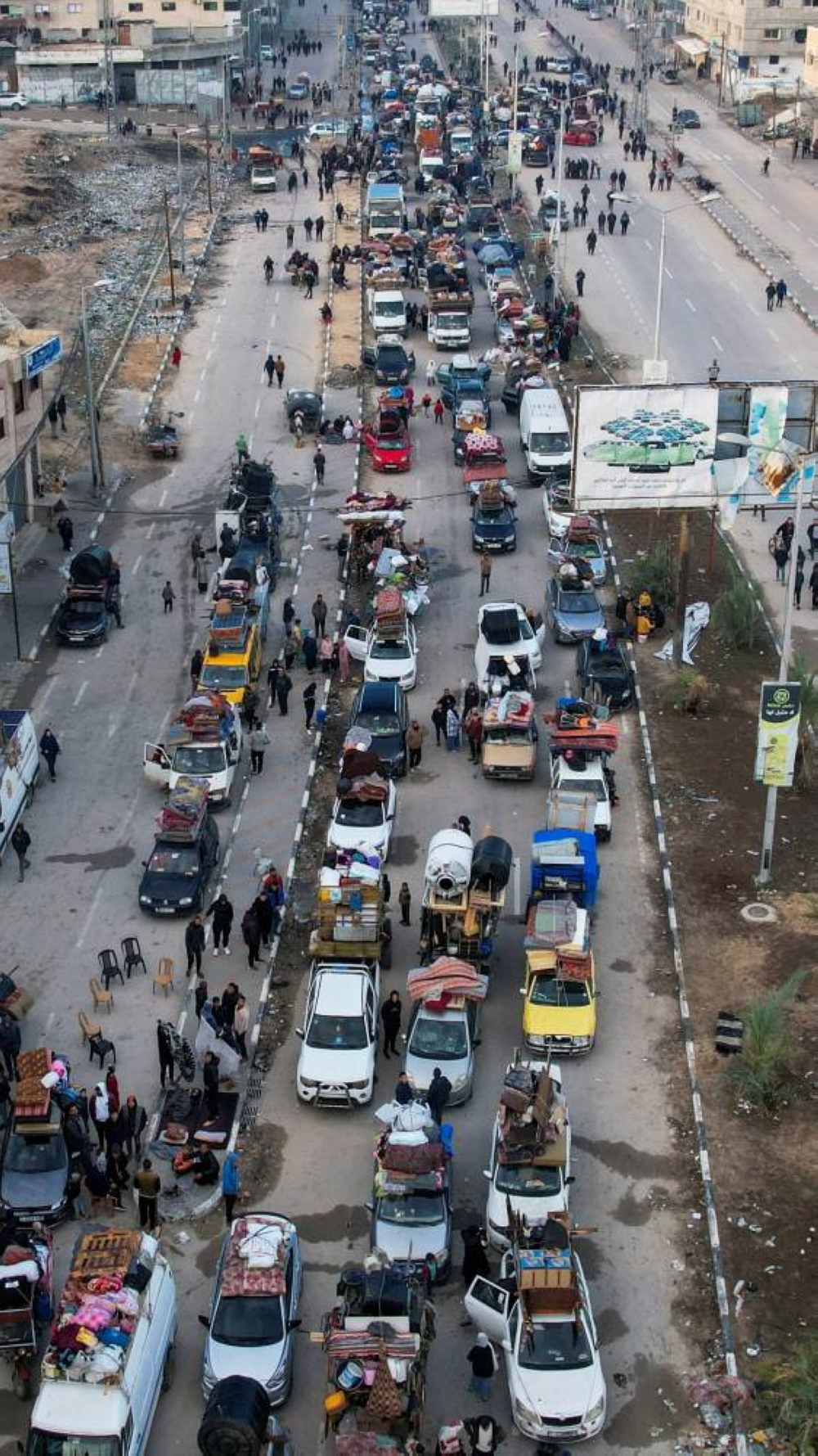 A drone view shows Palestinians waiting to be allowed to return to their homes in northern Gaza after they were displaced to the south at Israel's order during the war, in the central Gaza Strip, on Sunday. REUTERS