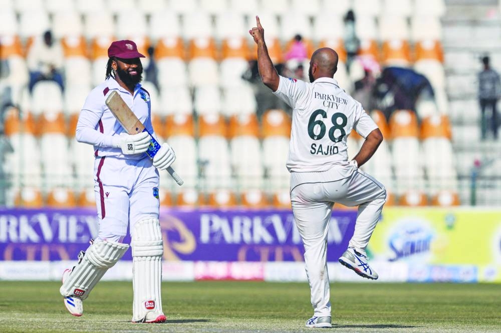 
Pakistan’s Sajid Khan (right) celebrates after taking the wicket of West Indies’ Jomel Warrican (left) yesterday. (AFP) 