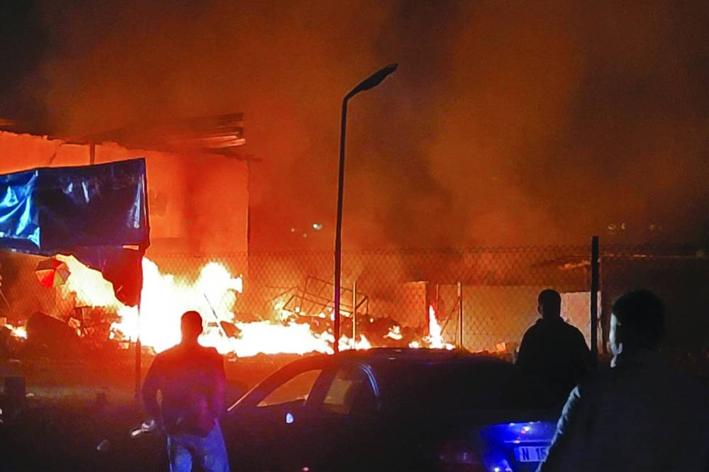 Rescuers rush to the site of an Israeli air strike that targeted an area in the southern Lebanese village of Nabatiyeh, yesterday.