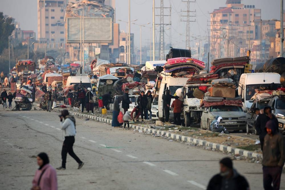 Displaced Palestinians move with their belongings on Salah al-Din road as people make their way from the south to the northern parts of the Gaza Strip, in Nuseirat in central Gaza, on Wednesday. AFP