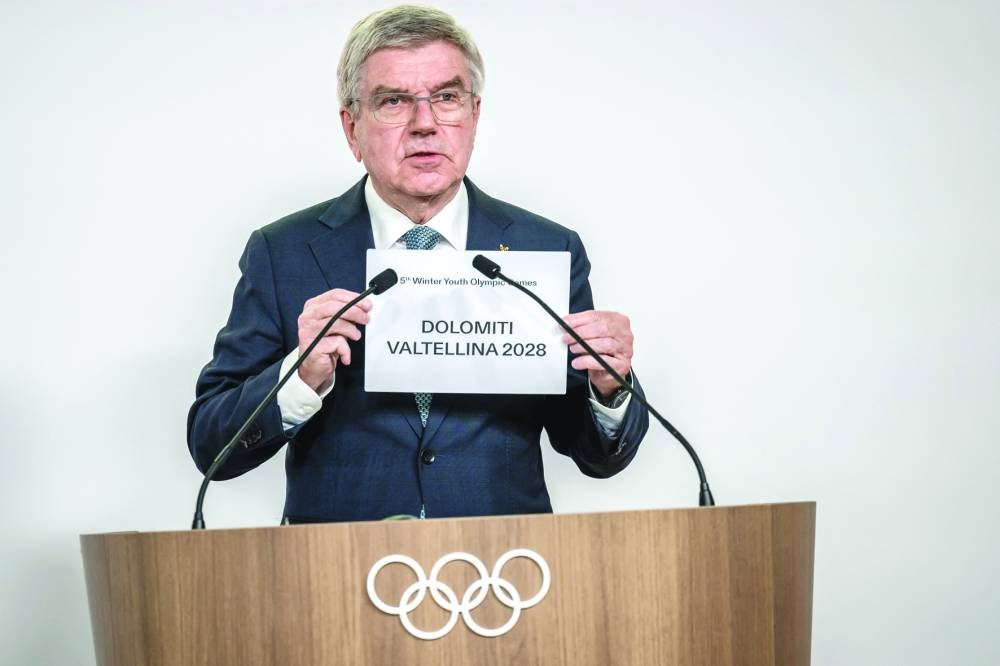 International Olympic Committee President Thomas Bach holds a sheet of paper that reads ‘Dolomiti Valtellina 2028’ after Italy’s Dolomiti Valtellina was confirmed as host of the 2028 Winter Youth Olympic Games (YOG), in a vote by the 143rd IOC Session, in Lausanne on Thursday. (AFP)