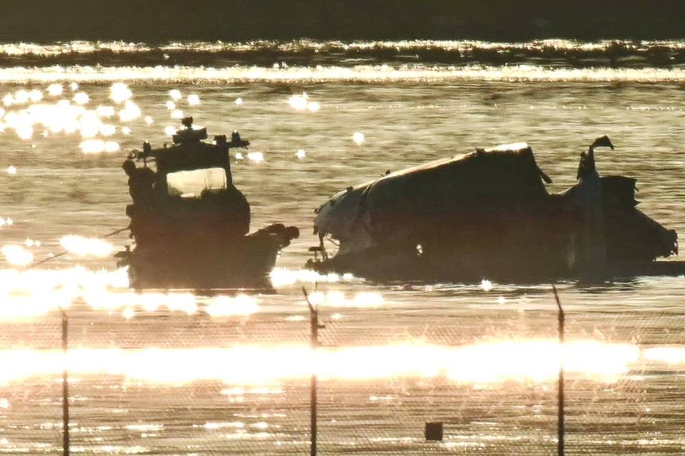 Part of the wreckage is seen as rescue crews search the waters of the Potomac River after a passenger plane on approach to Reagan National Airport crashed into the river after colliding with a US Army helicopter, near Washington, DC, on Thursday. (AFP)