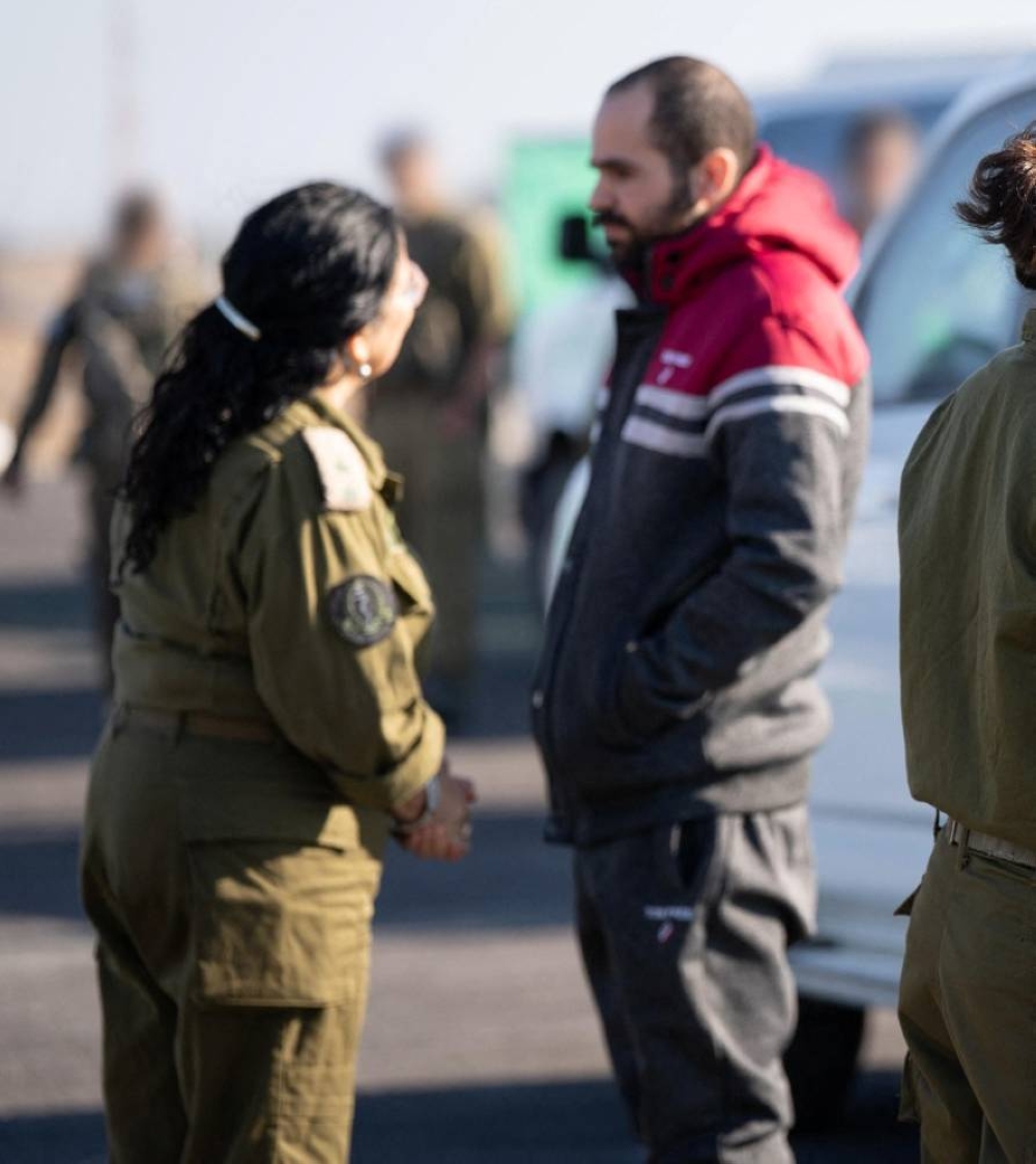 Released Israeli hostage, Yarden Bibas speaks with an Israeli officer, in a handout photo obtained by Reuters on Saturday. IDF/Handout via REUTERS