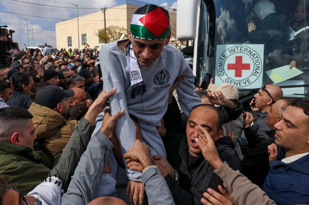 A former Palestinian prisoner released by Israel is cheered upon his arrival in Ramallah on buses of the International Committee of the Red Cross (ICRC) on Saturday. AFP