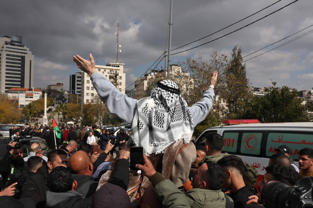 A former Palestinian prisoner released by Israel is cheered upon his arrival in Ramallah on buses of the International Committee of the Red Cross (ICRC) on Saturday. AFP
